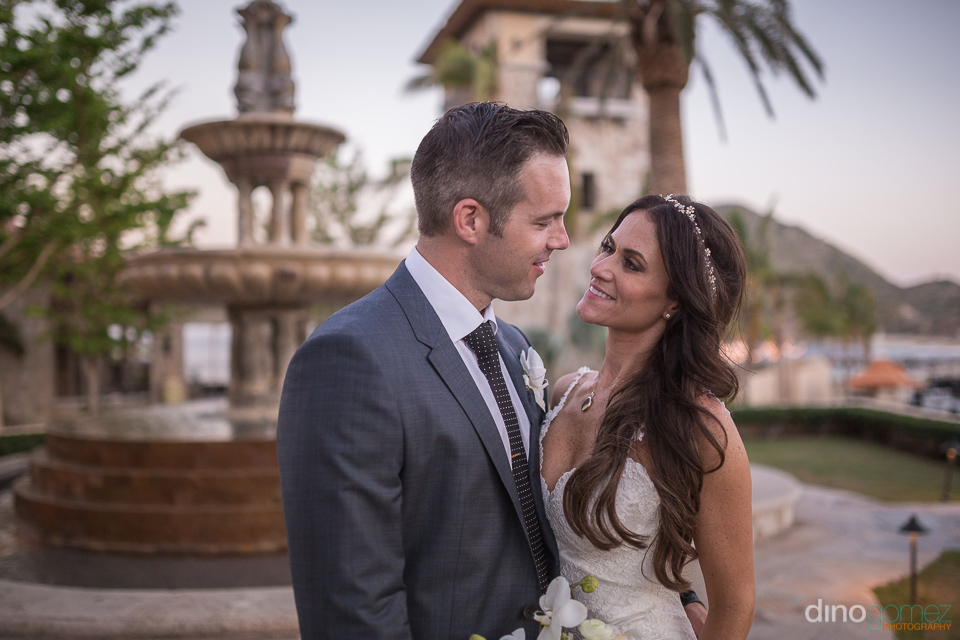 bride and groom in front of a fountain - Monica & Parker Wedding