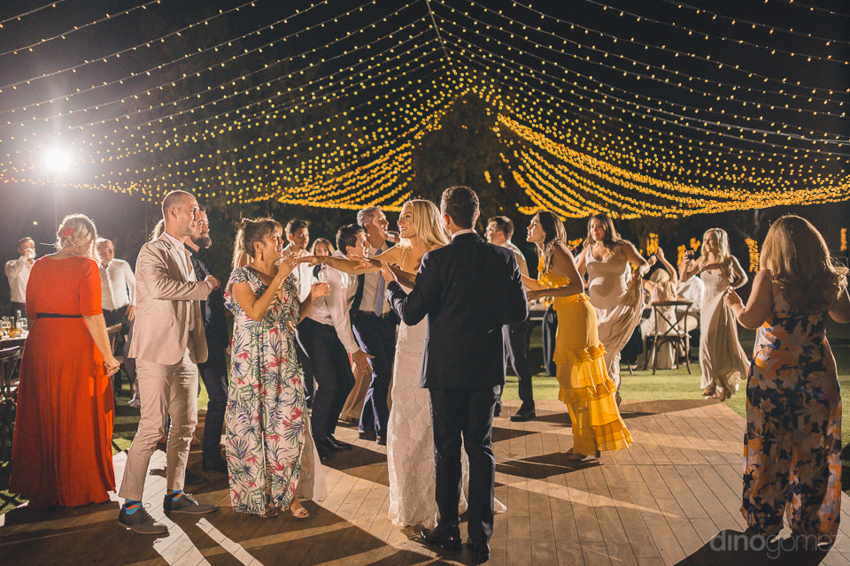 guests join bride and groom on dance floor at flora farms weddin