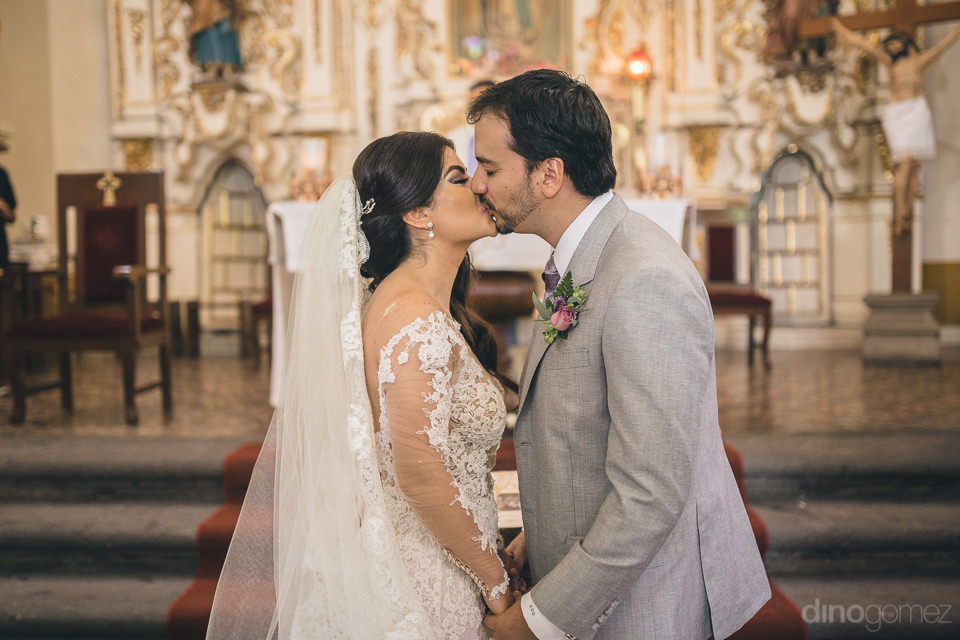 newlyweds kiss at the end of their wedding ceremony photos by me