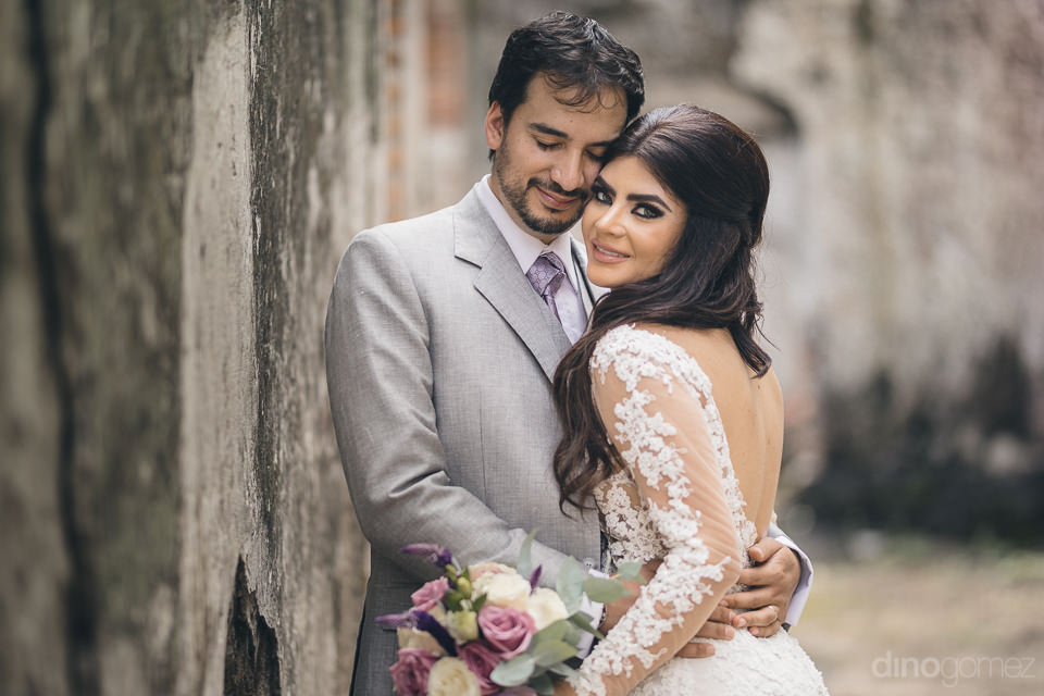 bride and groom embrace in heartwarming wedding photo at haciend